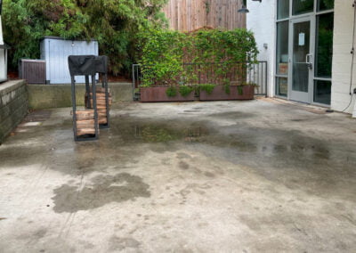 Stained patio prior to pressure wash.