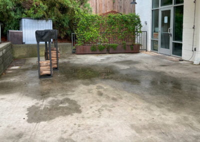 Stained patio prior to pressure wash.