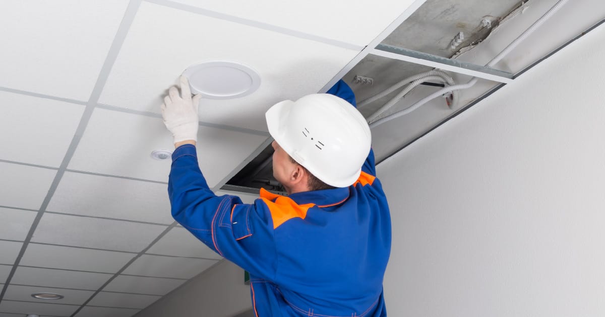 An onsite day porter changing a lightbulb