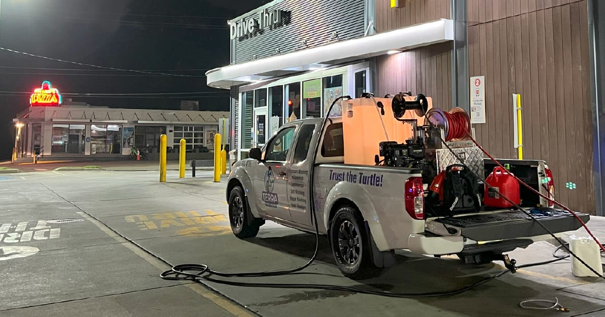 Terra CPS truck pressure washing a commercial drive-thru